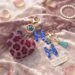 Personalized fuchsia plush heart keychain with blue acrylic letter for backpack