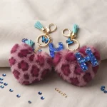 Personalized fuchsia plush heart keychain with blue acrylic letter for backpack
