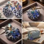 Personalized grey plush heart keychain with blue acrylic initial for backpack