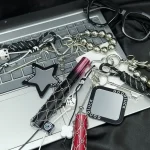 Vintage braided keychain with antique silver charms and star mirror, black and white paracord bag charm.