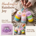 Close-up of fluffy worm monster keychain showing hand-stitched smiley face and soft faux fur texture.