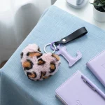 Close-up of the initial heart keychain showing leopard faux fur heart and stitched PU leather letter.