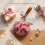 Close-up of the initial letter keychain showing stitched PU leather letter and leopard faux fur heart.
