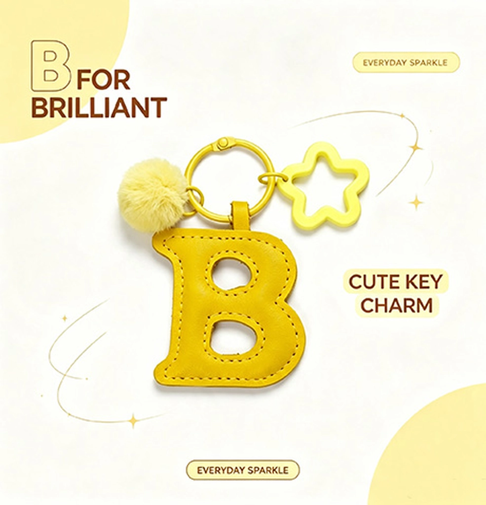 Close-up of the Letter B keychain showing hand-stitched yellow PU leather and soft faux fur pom pom.