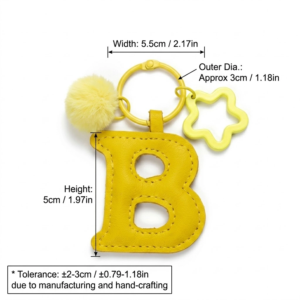 Close-up of the letter pom pom keychain showing stitched yellow PU leather letter and faux fur pom pom.