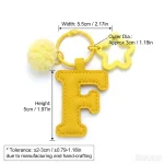 Close-up of the Letter F keychain showing padded sunny yellow PU leather and soft faux fur pom pom.