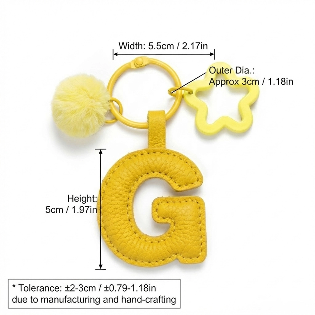 Close-up of the Letter G keychain showing padded gentle yellow PU leather and soft faux fur pom pom.