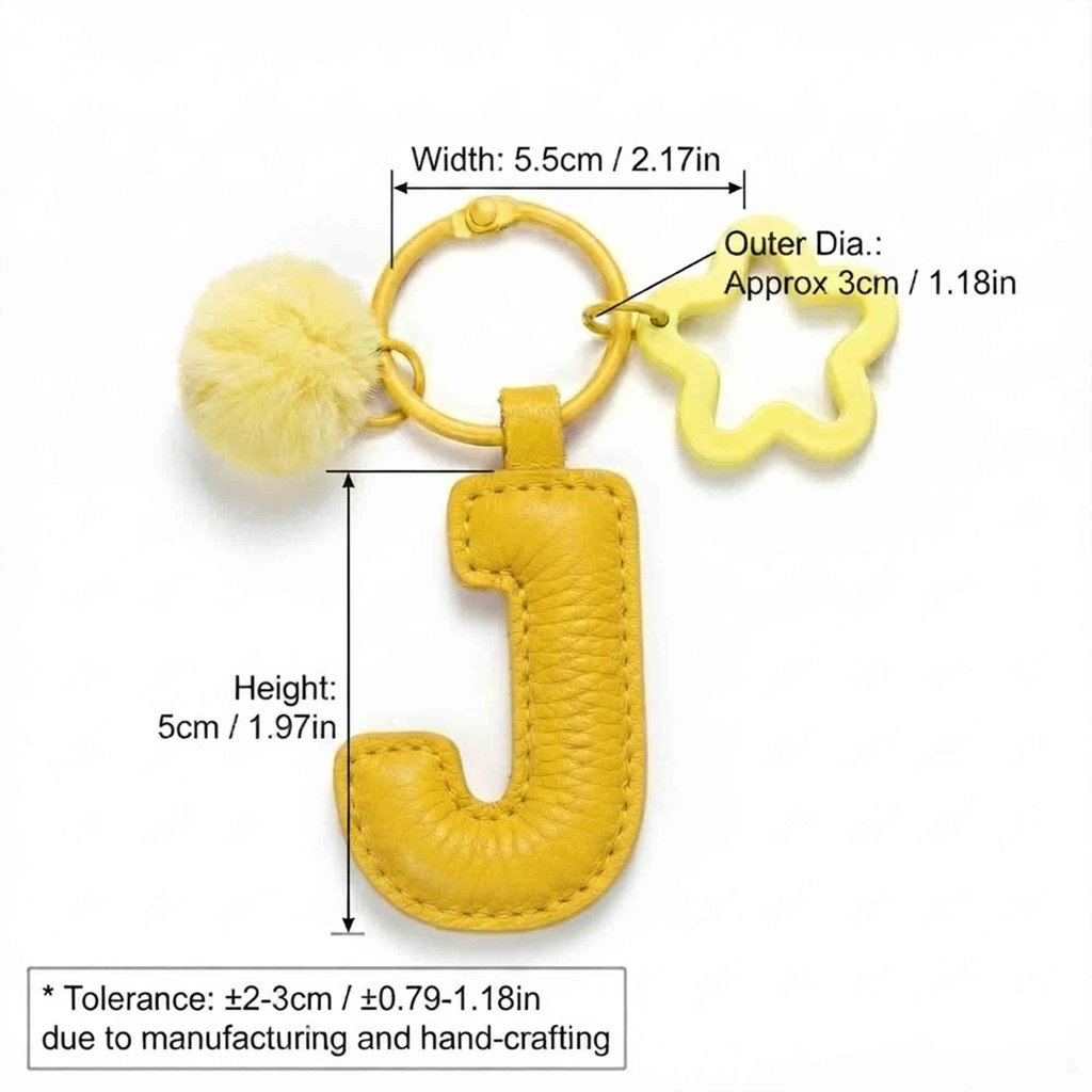 Close-up of the Letter J keychain showing padded jelly yellow PU leather and soft faux fur pom pom.