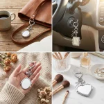 Open folding compact mirror inside the silver heart mirror keychain showing clear HD glass.
