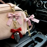 Gold Lip Gloss Bag Charm with Satin Bow and Heart Mirror, Portable Lipstick Cage Keychain Gift