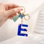 Blue glitter letter O keychain with butterfly and tassel (LOVE collection).