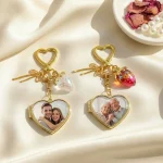 8 color variations of gold heart locket keychain with cute strawberry charms.