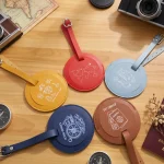 Yellow round leather luggage tag, laser engraved sun beach icons, travel accessory.